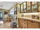 Dining room with built-in cabinets, glassware display, tile countertops, and bar cart at 17706 Morninghigh Dr, Lutz, FL 33549