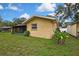 Exterior of the home with a screened patio, well-maintained lawn, and mature landscaping at 17706 Morninghigh Dr, Lutz, FL 33549