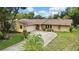 Charming single-story home with an attached garage, landscaped front yard, and a welcoming driveway at 17706 Morninghigh Dr, Lutz, FL 33549