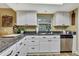 Kitchen featuring stainless steel appliances, white cabinets, and a granite countertop at 17706 Morninghigh Dr, Lutz, FL 33549