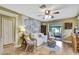 Bright living area featuring hardwood floors, comfortable seating, and access to a screened-in patio at 17706 Morninghigh Dr, Lutz, FL 33549