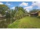 Beautiful canal-front property with lush landscaping, offering serene outdoor living at 17706 Morninghigh Dr, Lutz, FL 33549