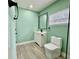 Modern bathroom features a white vanity, black fixtures, and neutral tile flooring at 1813 E Wood St, Tampa, FL 33604