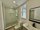 Well-lit bathroom features a glass-enclosed shower and a contemporary vanity at 1813 E Wood St, Tampa, FL 33604
