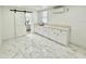Large bonus room with a wet bar, marble floors, and a sliding barn door to the bathroom at 1813 E Wood St, Tampa, FL 33604