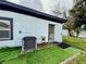 Exterior of home with new AC and open backdoor at 1813 E Wood St, Tampa, FL 33604