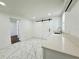 Bright kitchen with white cabinetry, quartz countertops, and sliding barn door at 1813 E Wood St, Tampa, FL 33604