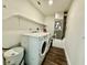 Laundry room features a white washer and dryer with floating shelves above at 1813 E Wood St, Tampa, FL 33604