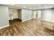 Spacious living room showcasing hardwood floors, freshly painted walls and ample natural light at 1813 E Wood St, Tampa, FL 33604