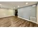 Spacious living room showcasing hardwood floors, freshly painted walls and ample natural light at 1813 E Wood St, Tampa, FL 33604
