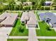Beautiful aerial view of a single-Gathering home with a well-manicured lawn and neighboring houses at 19974 Bluebird Meadow Dr, Lutz, FL 33558