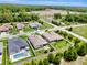 An aerial view of a residential neighborhood featuring manicured lawns, pools, and a serene environment at 19974 Bluebird Meadow Dr, Lutz, FL 33558