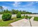 A backyard with a green lawn, privacy fence, and a concrete patio at 19974 Bluebird Meadow Dr, Lutz, FL 33558