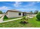 Backyard with manicured lawn, concrete path, and privacy fence at 19974 Bluebird Meadow Dr, Lutz, FL 33558