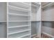 Organized walk-in closet featuring built-in shelving for optimal storage at 19974 Bluebird Meadow Dr, Lutz, FL 33558