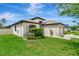 Attractive home featuring well-kept landscaping, a lush lawn, and a neutral color scheme at 19974 Bluebird Meadow Dr, Lutz, FL 33558