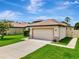 Attractive home featuring well-kept landscaping, a lush lawn, and a two-car garage at 19974 Bluebird Meadow Dr, Lutz, FL 33558