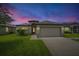 Charming single-story home with a well-maintained lawn and two-car garage at 19974 Bluebird Meadow Dr, Lutz, FL 33558