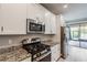 Well-appointed kitchen with granite countertops, gas range, stainless steel appliances and plenty of cabinet storage at 19974 Bluebird Meadow Dr, Lutz, FL 33558