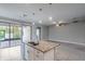 Beautiful kitchen featuring a granite island with sink, stainless steel appliances, and a sliding glass door at 19974 Bluebird Meadow Dr, Lutz, FL 33558
