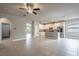 Spacious living room with tile flooring that flows into a modern kitchen with stainless steel appliances at 19974 Bluebird Meadow Dr, Lutz, FL 33558