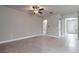Open-concept living room featuring tile flooring, neutral wall color, and ample natural light at 19974 Bluebird Meadow Dr, Lutz, FL 33558