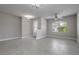 Spacious living room with tile floors, neutral paint, and ample natural light from a large window at 19974 Bluebird Meadow Dr, Lutz, FL 33558