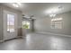 Bright and airy living room featuring tile flooring, a ceiling fan, and a modern chandelier at 19974 Bluebird Meadow Dr, Lutz, FL 33558