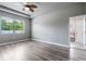 Bright main bedroom with hardwood floors and a door leading to the main bath at 19974 Bluebird Meadow Dr, Lutz, FL 33558