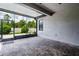 A covered patio with a stone floor is open to the grassy yard at 19974 Bluebird Meadow Dr, Lutz, FL 33558