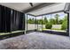 Screened patio with stone floor, ceiling fan, and views of fenced yard at 19974 Bluebird Meadow Dr, Lutz, FL 33558