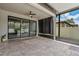 Screened patio featuring stone floor, ceiling fan, and a view into the backyard at 19974 Bluebird Meadow Dr, Lutz, FL 33558
