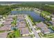 An aerial view of the community pond, street, and well-manicured neighborhood at 21797 Briske Morning Ave, Land O Lakes, FL 34637