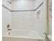 Bathroom featuring a bathtub with white tile surround, shower head, and decorative tile accents at 21797 Briske Morning Ave, Land O Lakes, FL 34637