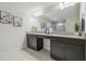 Bright bathroom with a granite countertop, vanity with dark cabinets, and decorative wall art at 21797 Briske Morning Ave, Land O Lakes, FL 34637