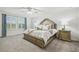 Primary bedroom with plantation shutters, an upholstered headboard, and matching nightstands at 21797 Briske Morning Ave, Land O Lakes, FL 34637