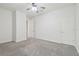 Bedroom with neutral carpet, white ceilings and walls, and recessed lighting, with two white paneled doors at 21797 Briske Morning Ave, Land O Lakes, FL 34637