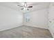 Inviting bedroom with carpet flooring, ceiling fan, and window allowing ample natural light at 21797 Briske Morning Ave, Land O Lakes, FL 34637