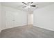 Bedroom featuring a ceiling fan, closet and doors with neutral carpet flooring at 21797 Briske Morning Ave, Land O Lakes, FL 34637