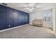 Comfortable bedroom featuring a modern blue accent wall and a crib at 21797 Briske Morning Ave, Land O Lakes, FL 34637