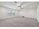 Spacious bedroom features neutral carpet, ceiling fan, recessed lighting, and a view through the windows at 21797 Briske Morning Ave, Land O Lakes, FL 34637
