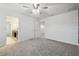 Spacious bedroom with grey carpet, ceiling fan, closet and ensuite bathroom at 21797 Briske Morning Ave, Land O Lakes, FL 34637