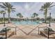 An inviting community pool features ample seating and palm trees at 21797 Briske Morning Ave, Land O Lakes, FL 34637