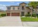 Beautiful two-story home featuring a stone facade, covered entry, and well-manicured landscaping at 21797 Briske Morning Ave, Land O Lakes, FL 34637