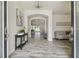 Elegant foyer with wood-look tile flooring, archways, and stylish furnishings at 21797 Briske Morning Ave, Land O Lakes, FL 34637