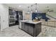 Modern kitchen with stainless steel appliances, dark cabinetry, large island, and pendant lighting at 21797 Briske Morning Ave, Land O Lakes, FL 34637