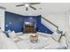Comfortable living room with a large sectional sofa, staircase, and blue accent wall at 21797 Briske Morning Ave, Land O Lakes, FL 34637