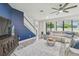 Cozy living room with a large sectional sofa, television, and staircase at 21797 Briske Morning Ave, Land O Lakes, FL 34637