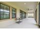 Spacious covered patio with ceiling fan and views of the manicured backyard and large sliding glass doors at 21797 Briske Morning Ave, Land O Lakes, FL 34637