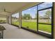 View of a large backyard from the covered patio, featuring a playset and well-maintained lawn at 21797 Briske Morning Ave, Land O Lakes, FL 34637